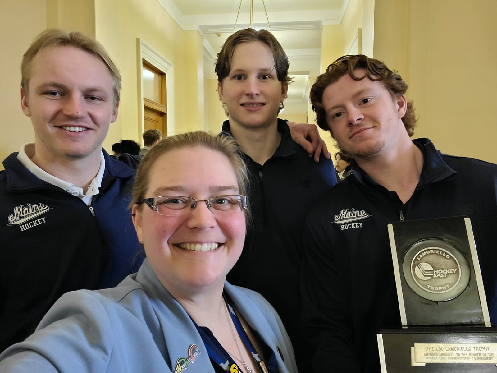 Rep. Collamore with the University of Maine hockey team and their Hockey East championship trophy