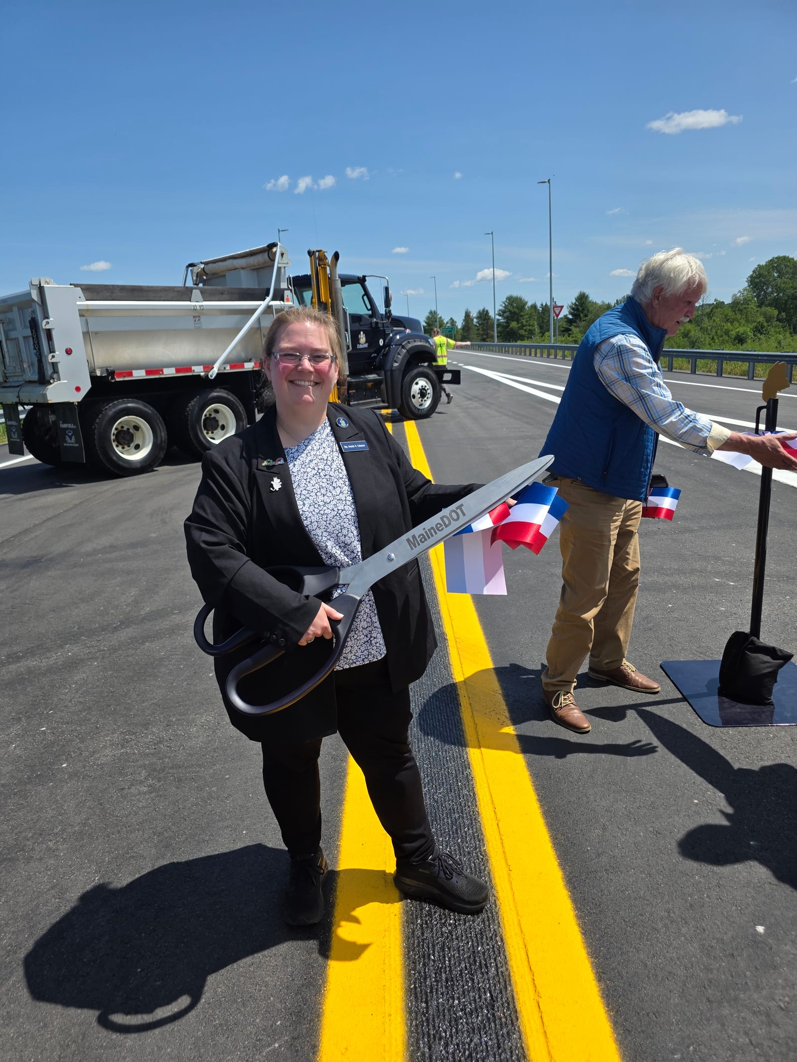 Rep. Collamore cutting the ribbon at a MaineDOT road project